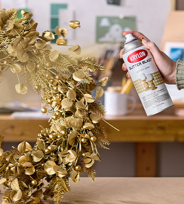 Spraying the wreath with Krylon Glitter Blast